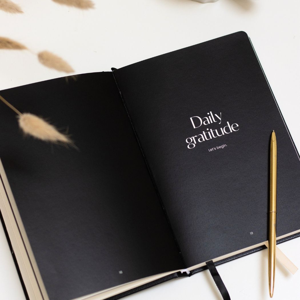 daily gratitude journal black on white desk